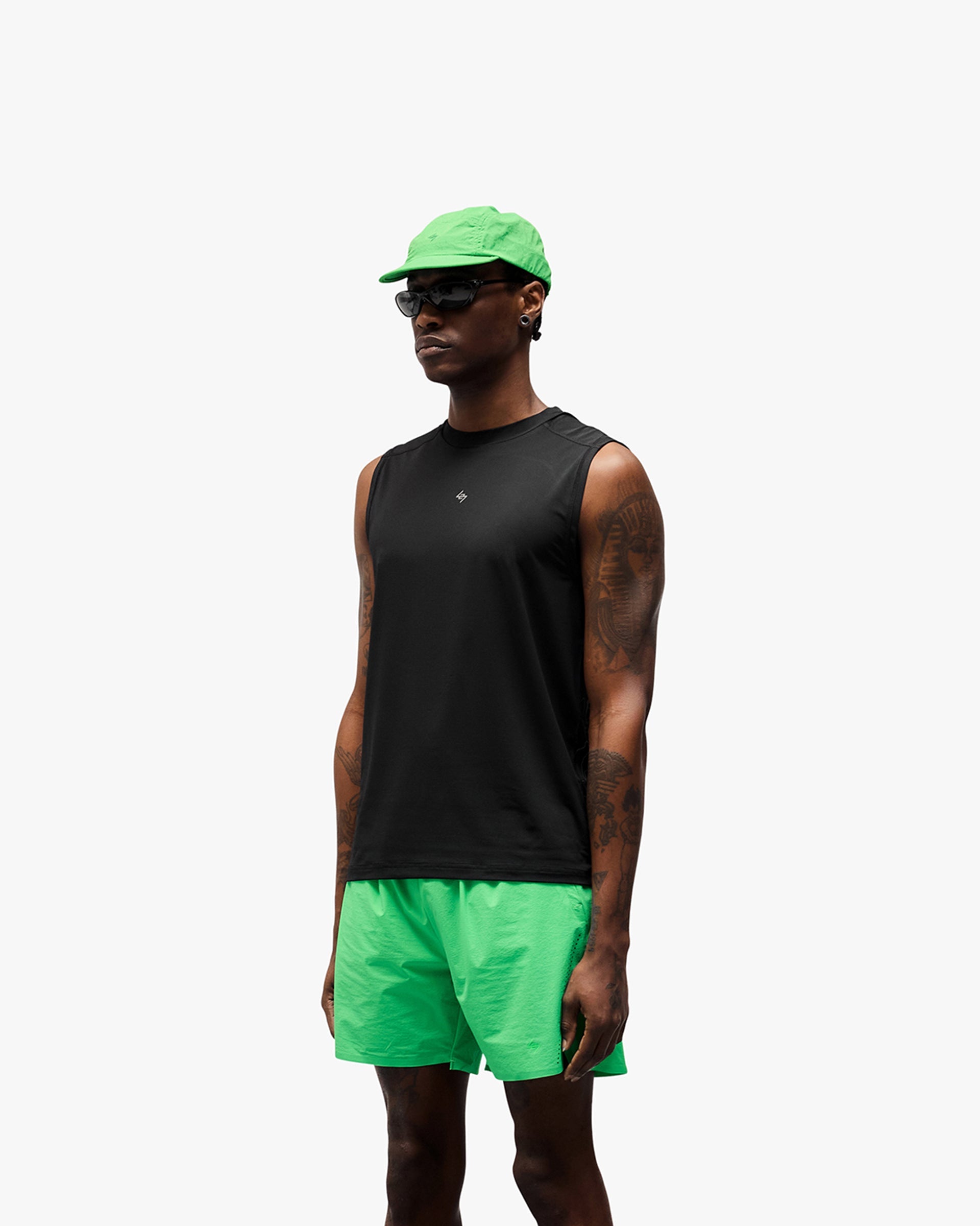 Man wearing a black running tank on a plain white background | 247 Contour Run Tank in Black | Breathable mesh and reflective print running tank | 247 T-Shirts | Represent Clo