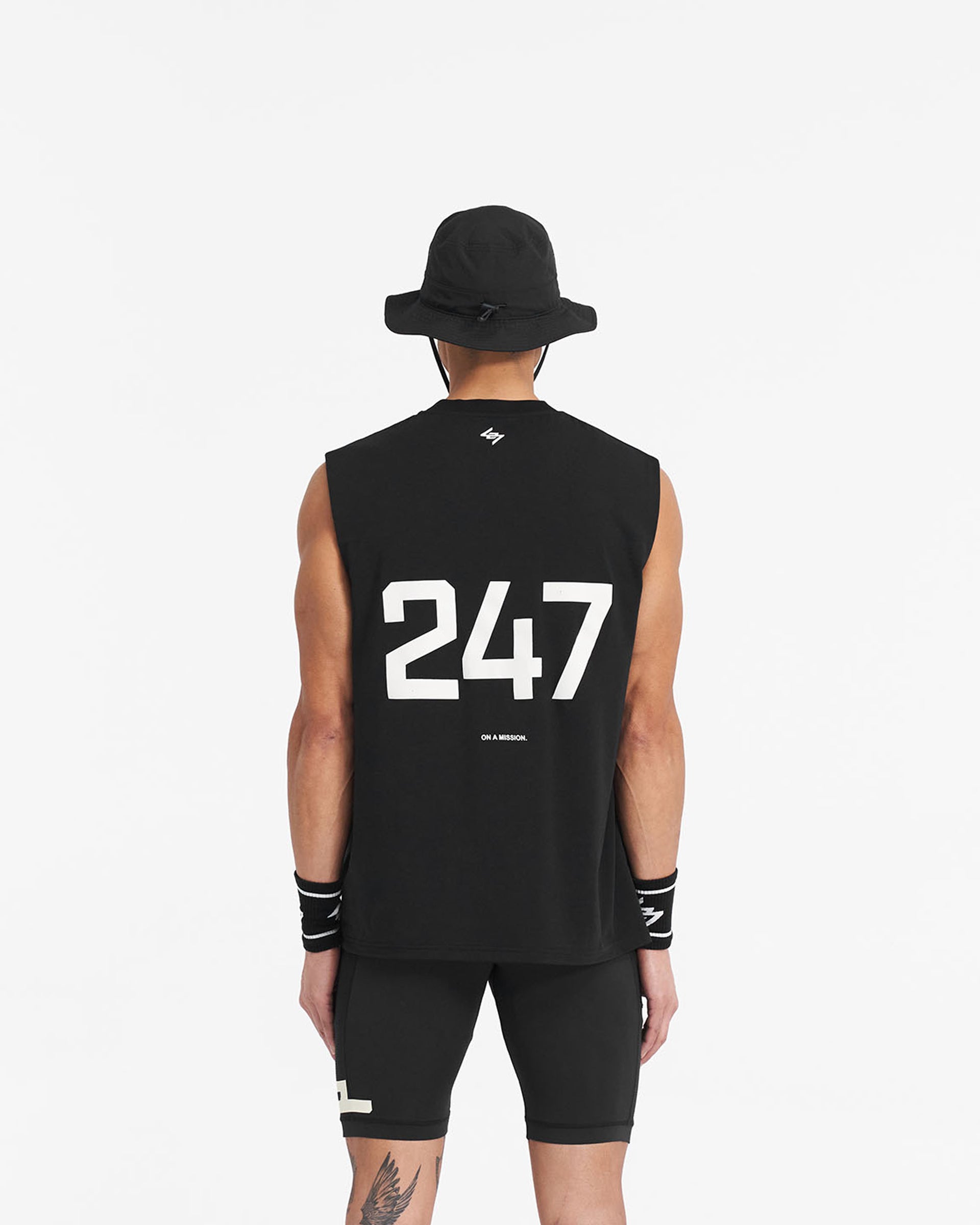 Man wearing a black oversized tank top on a plain white background | 247 Oversized Tank in Jet Black | Lightweight breathable tank with 4-way stretch | 247 T-Shirts | Represent Clo