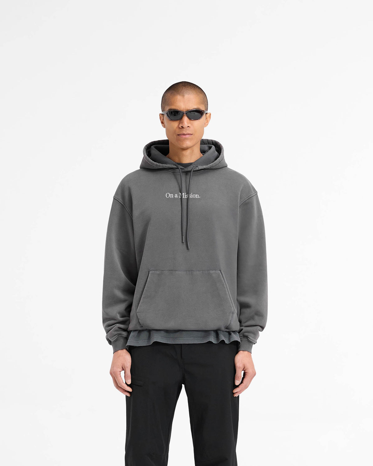 Man wearing a black hoodie on a plain white background | 247 On A Mission Hoodie in Aged Black | Slightly oversized hoodie with embroidery | 247 Hoodies | Represent Clo