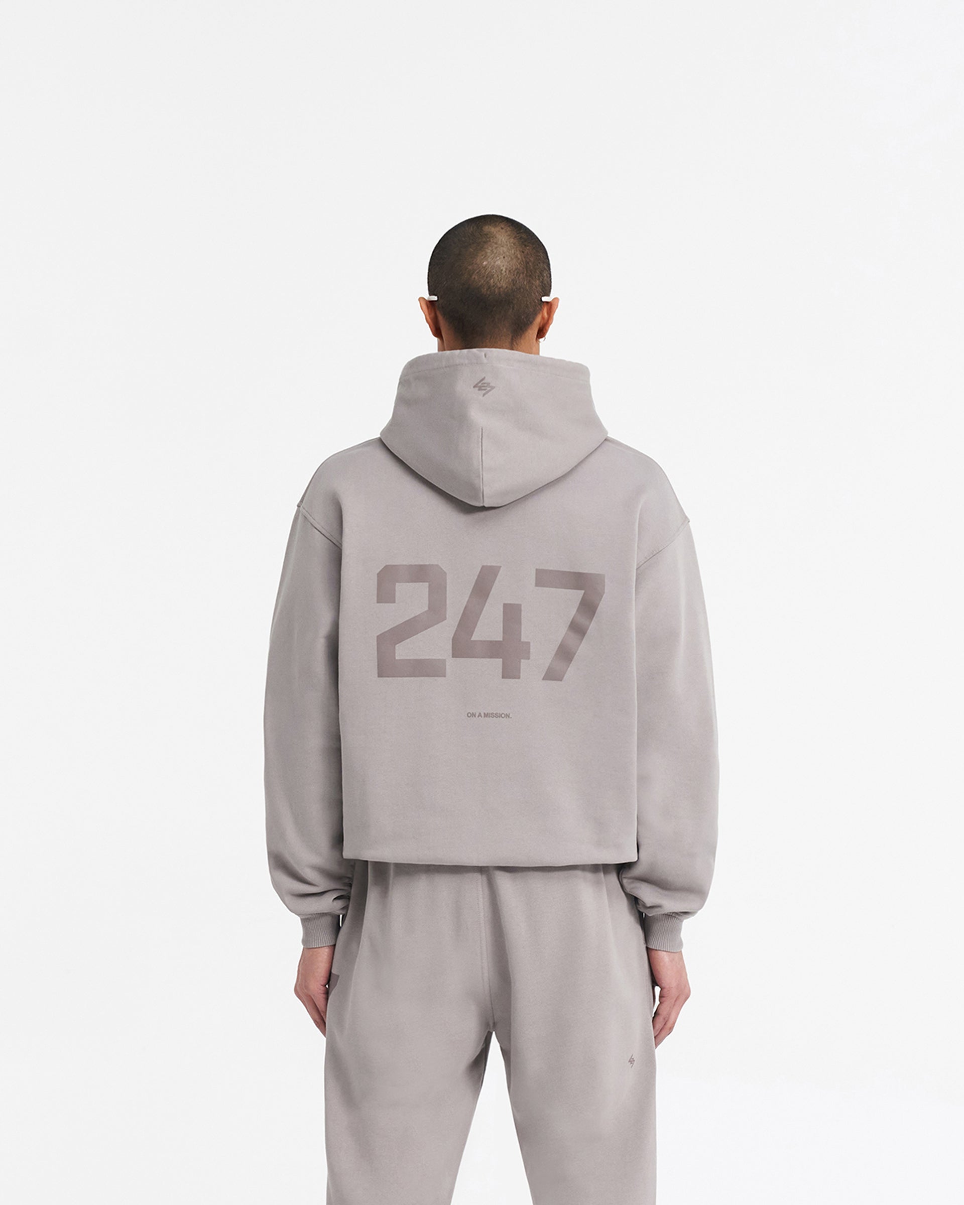Man wearing an oversized grey hoodie on a plain white background | 247 Oversized Hoodie in Cinder | Oversized hoodie with ribbed cuffs and hem | 247 Hoodies | Represent Clo