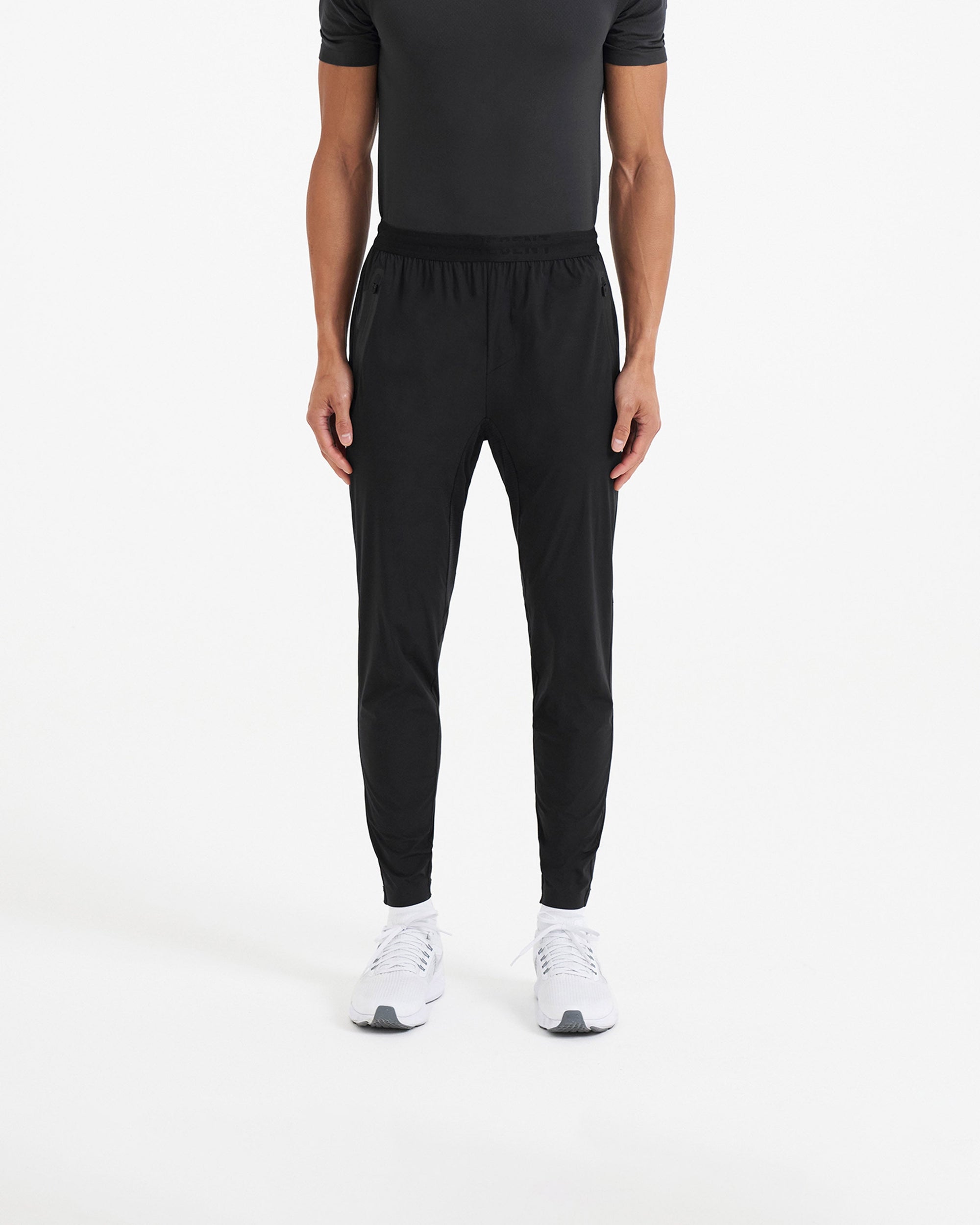 Back product image of mens black joggers on a plain white background | 247 Active Jogger in Black | Running pants with 4-way stretch and zip pockets | 247 Pants | Represent Clo