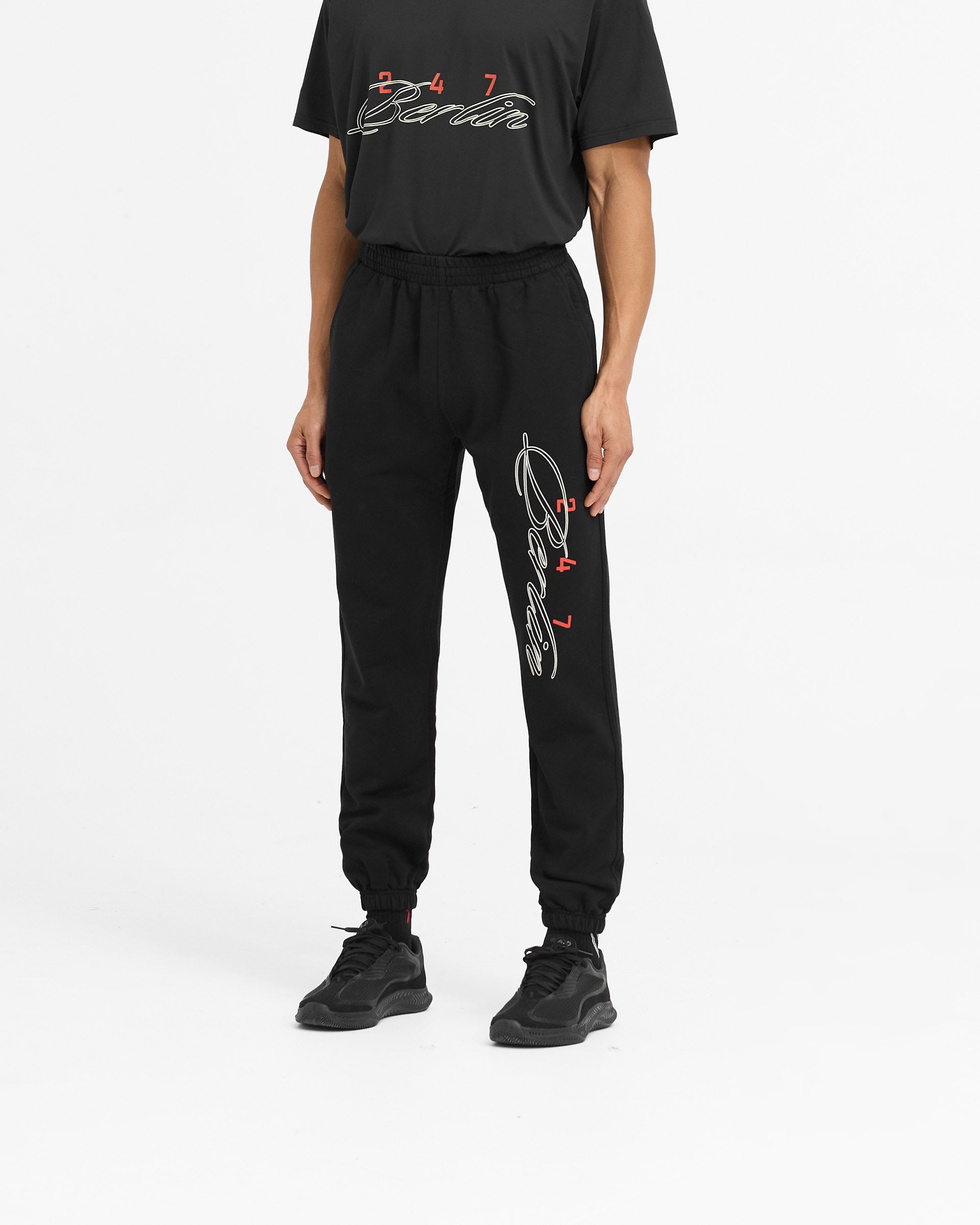 Back product image of mens black sweatpants on a plain white background | 247 Berlin Sweatpant in Black | Sweatpants with elasticated cuffs and drawcord waistband | 247 Pants | Represent Clo
