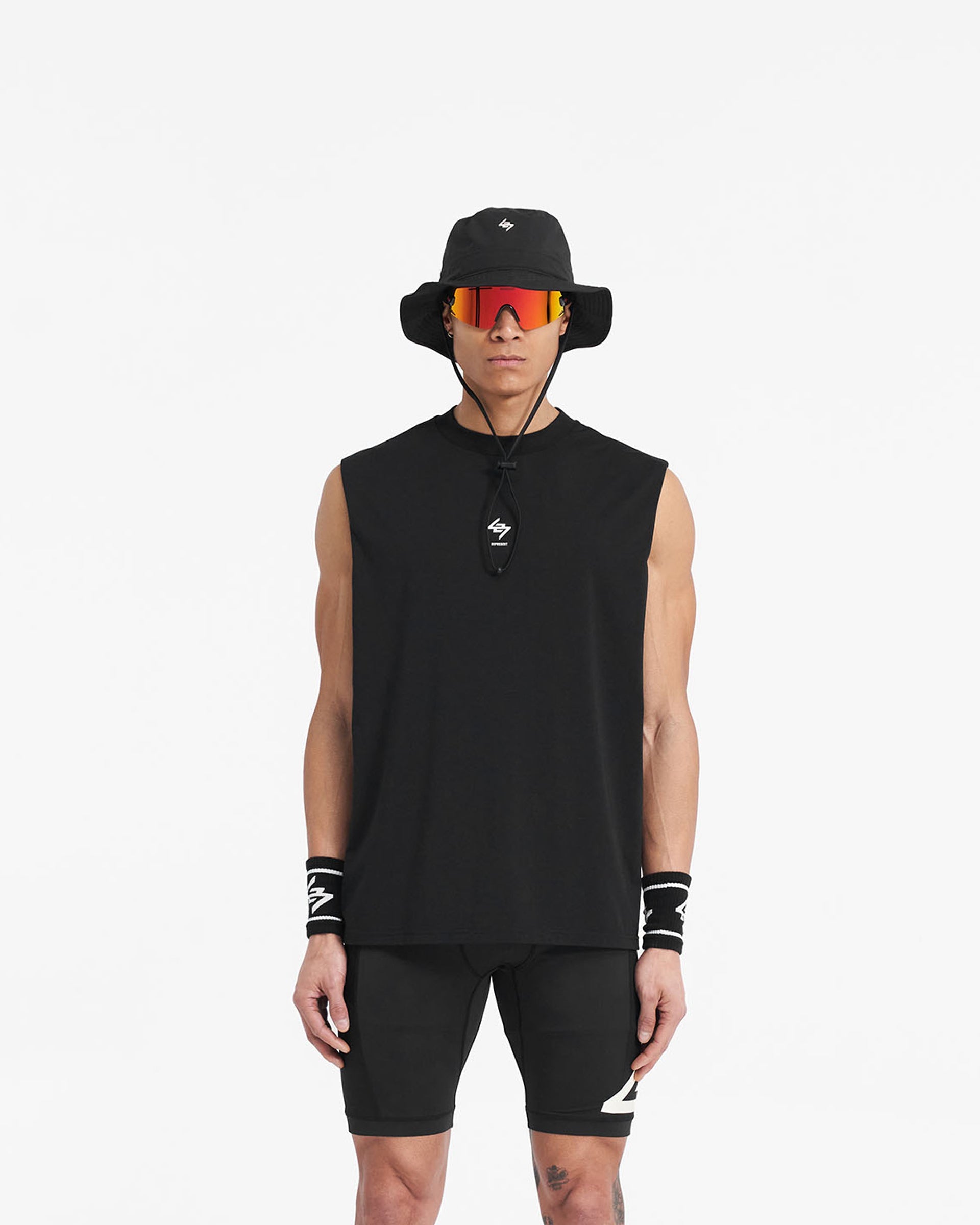 Man wearing an oversized black tank top on a plain white background | 247 Oversized Tank in Jet Black | Tank top with 4-way stretch and moisture-wicking features | 247 T-Shirts | Represent Clo