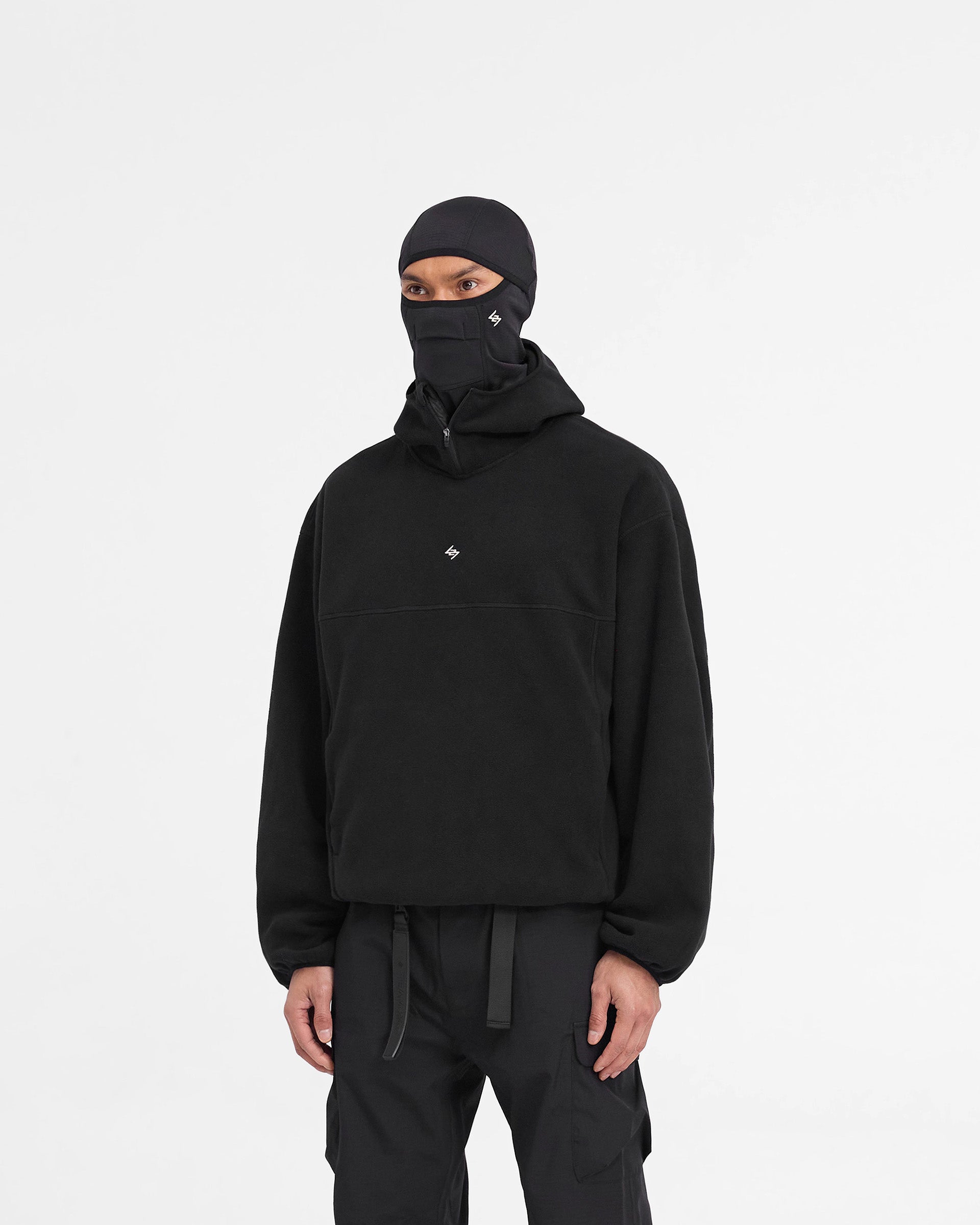 Man wearing a black fleece hoodie on a plain white background | 247 Fleece Hoodie in Black | Oversized fleece hoodie with zip pockets | 247 Hoodies | Represent Clo