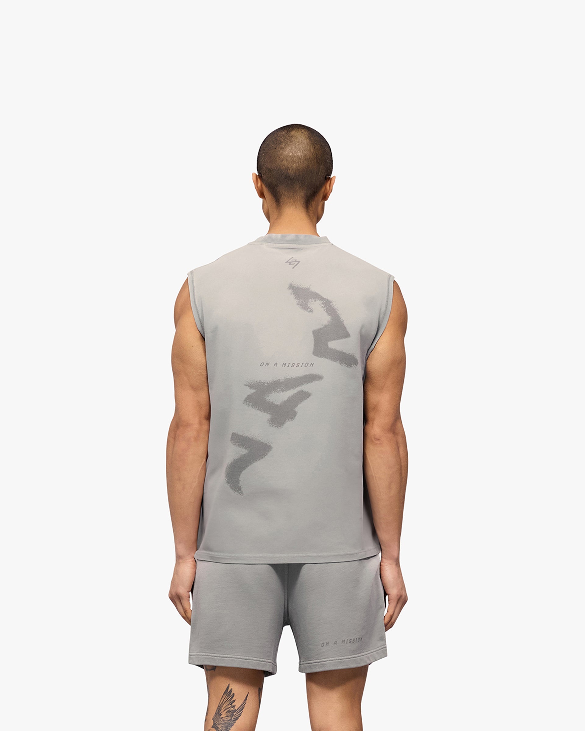 Man wearing a grey oversized tank top on a plain white background | 247 Motion Oversized Tank in Titanium | Oversized tank with sweat wicking and antibacterial properties | 247 T-Shirts | Represent Clo