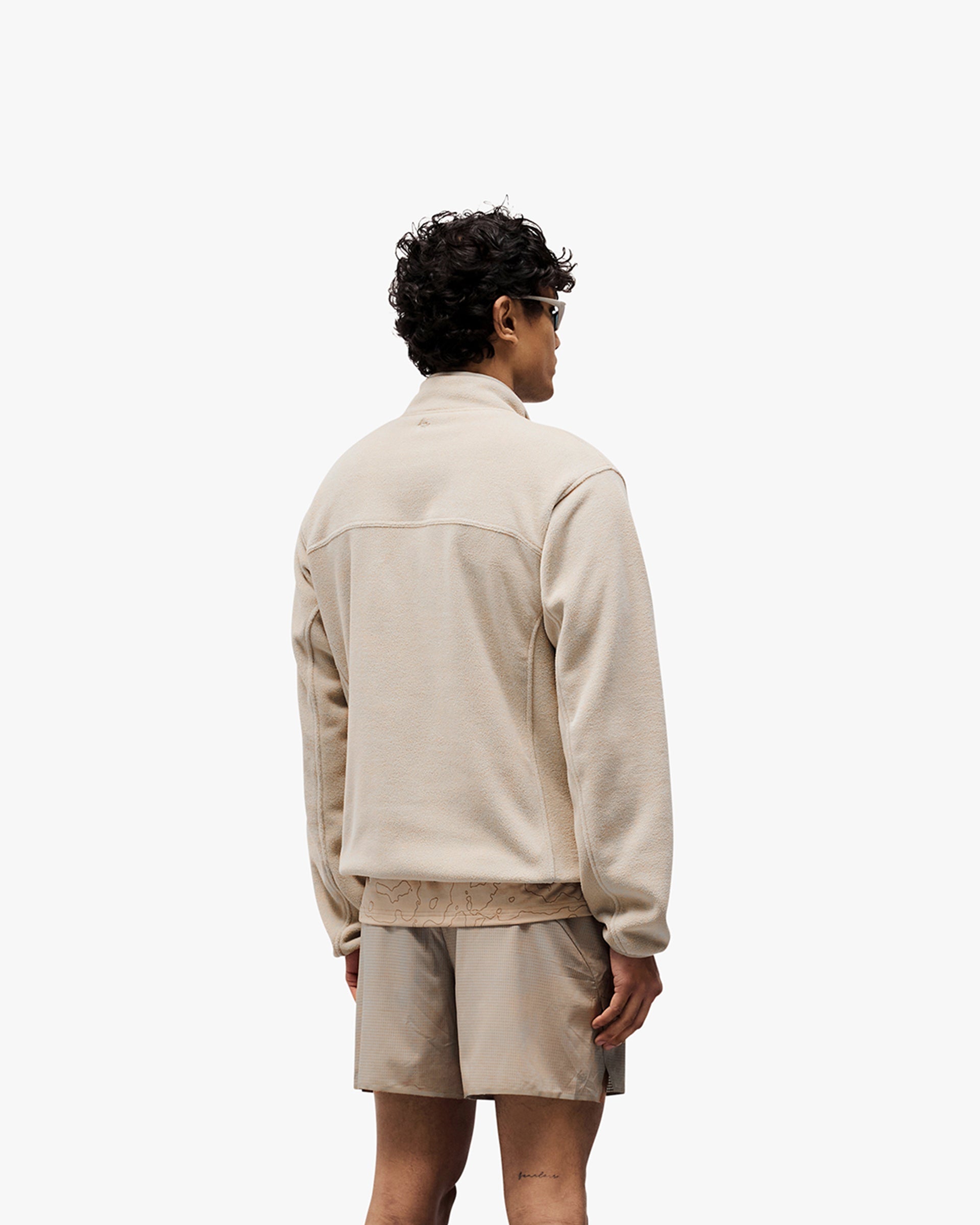 Man wearing a grey fleece on a plain white background | 247 Polar Panelled Fleece in Pebble | Fleece with zip pockets and toggle hem | 247 Outerwear | Represent Clo